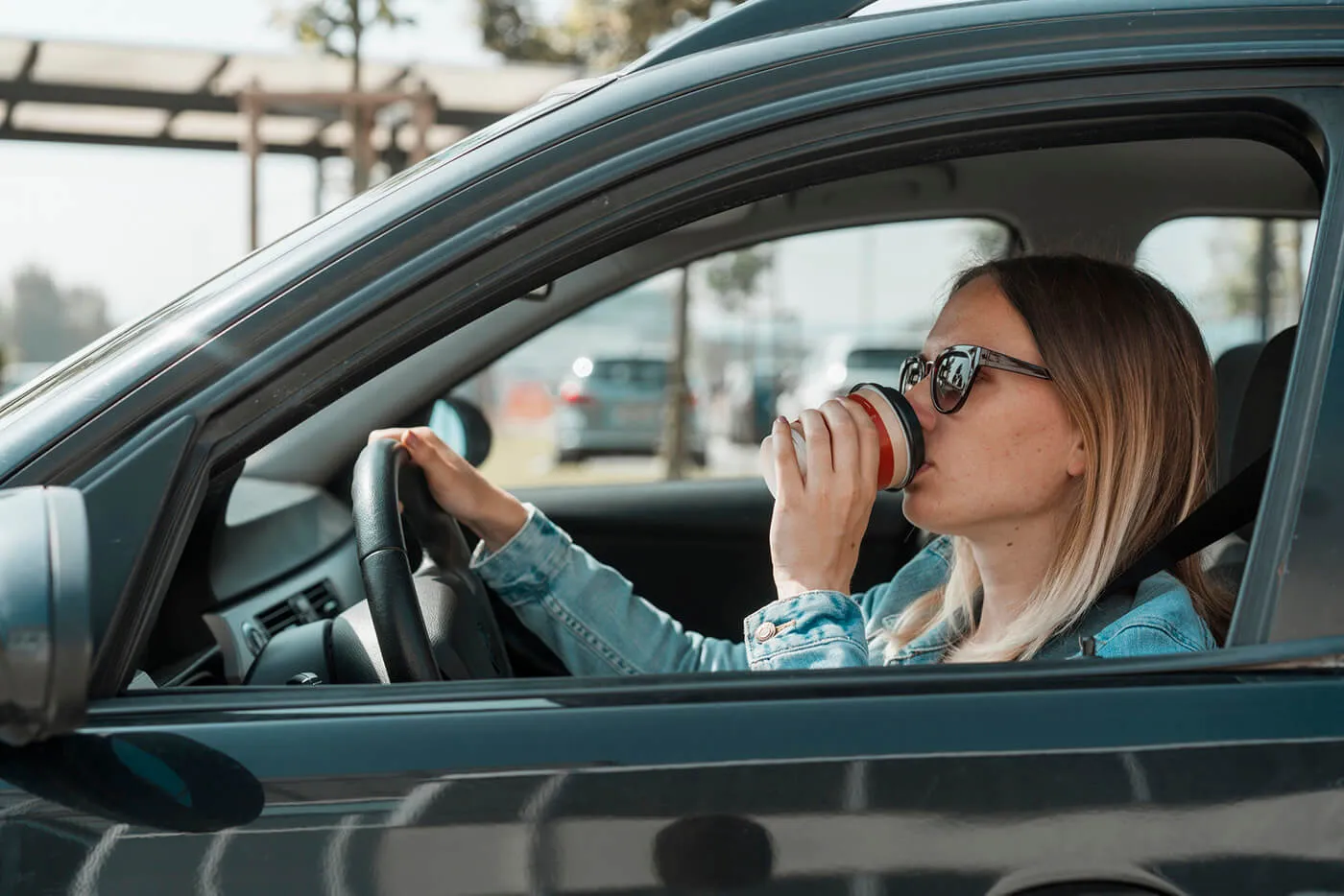 Wonam drinking morning coffee while driving to work
