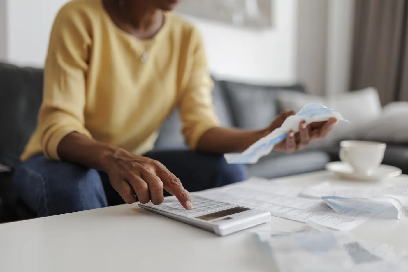 Close up of a mid adult woman checking her budget at home