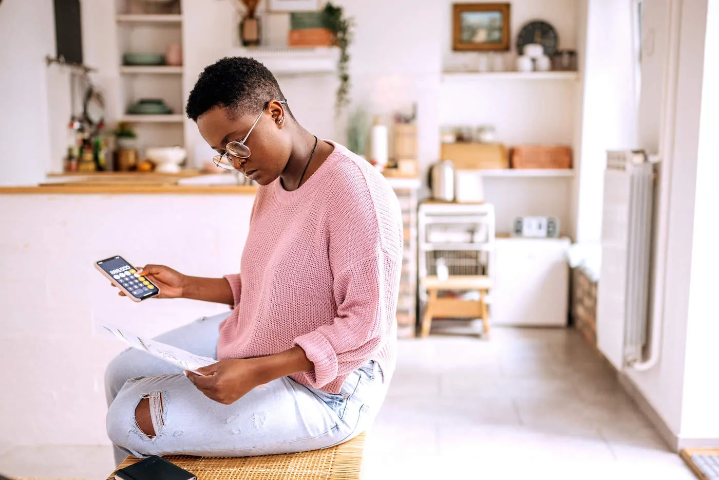 Seated woman in calculating expenses.